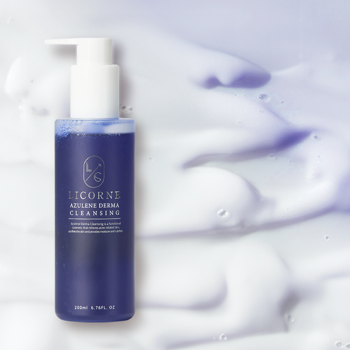 Blue skincare bottle with white pump on a light purple background