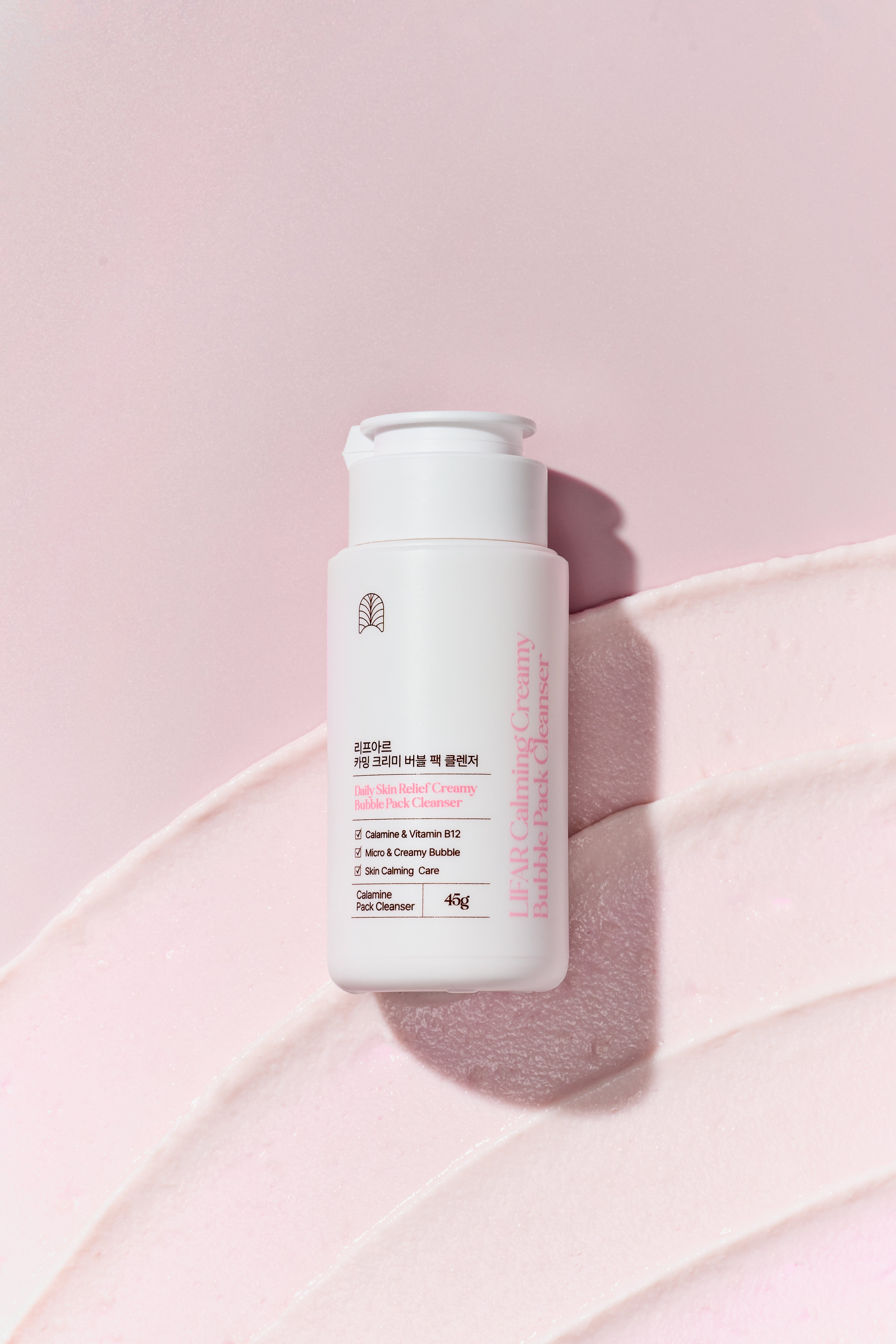 Skincare bottle on a pink background
