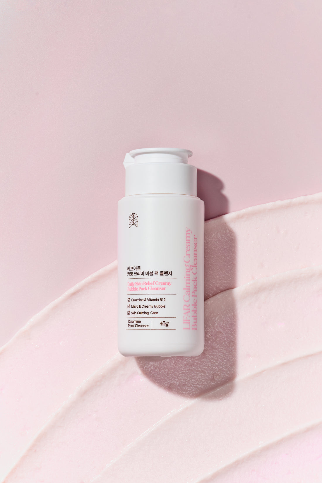 Skincare bottle on a pink background